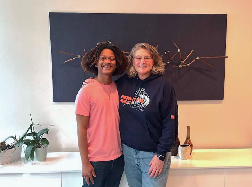 Two Wanta Thome team members standing together in the office