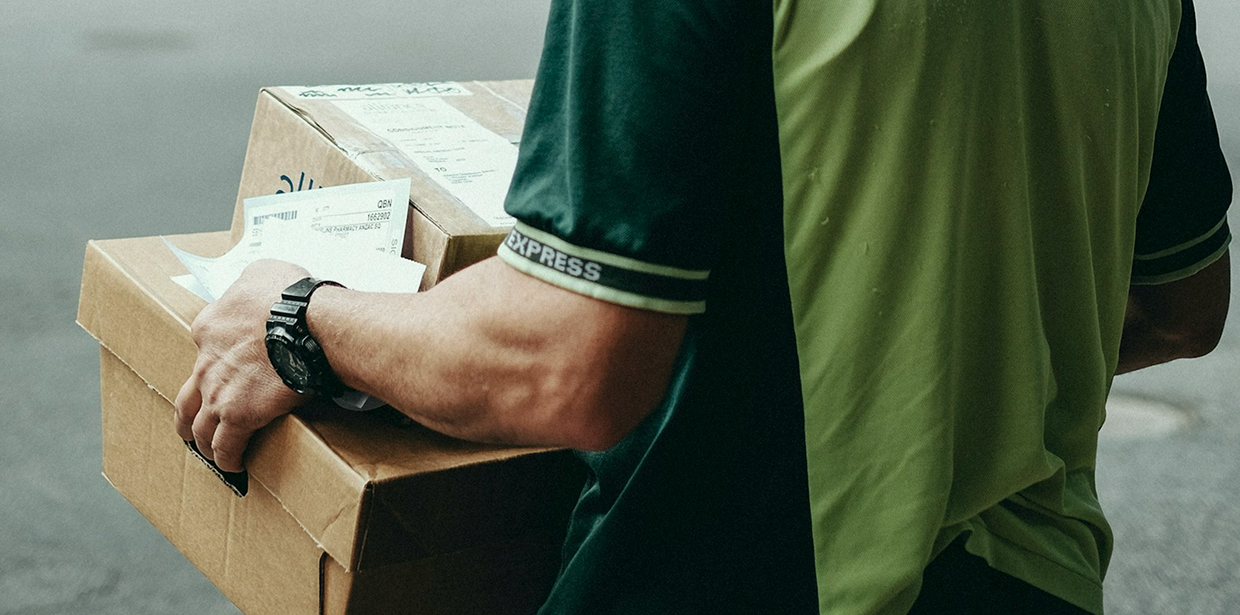 A delivery person carrying express shipping packages