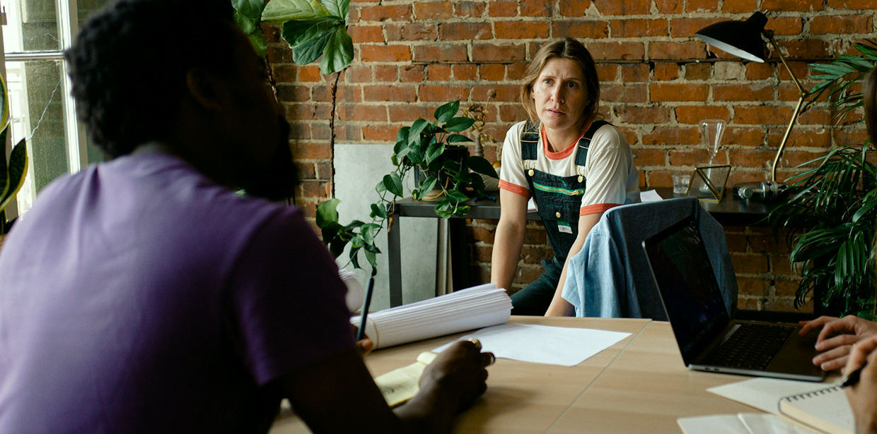 Woman listening during a meeting in a modern brick office