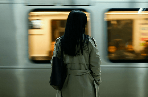 Commuter standing beside a subway train