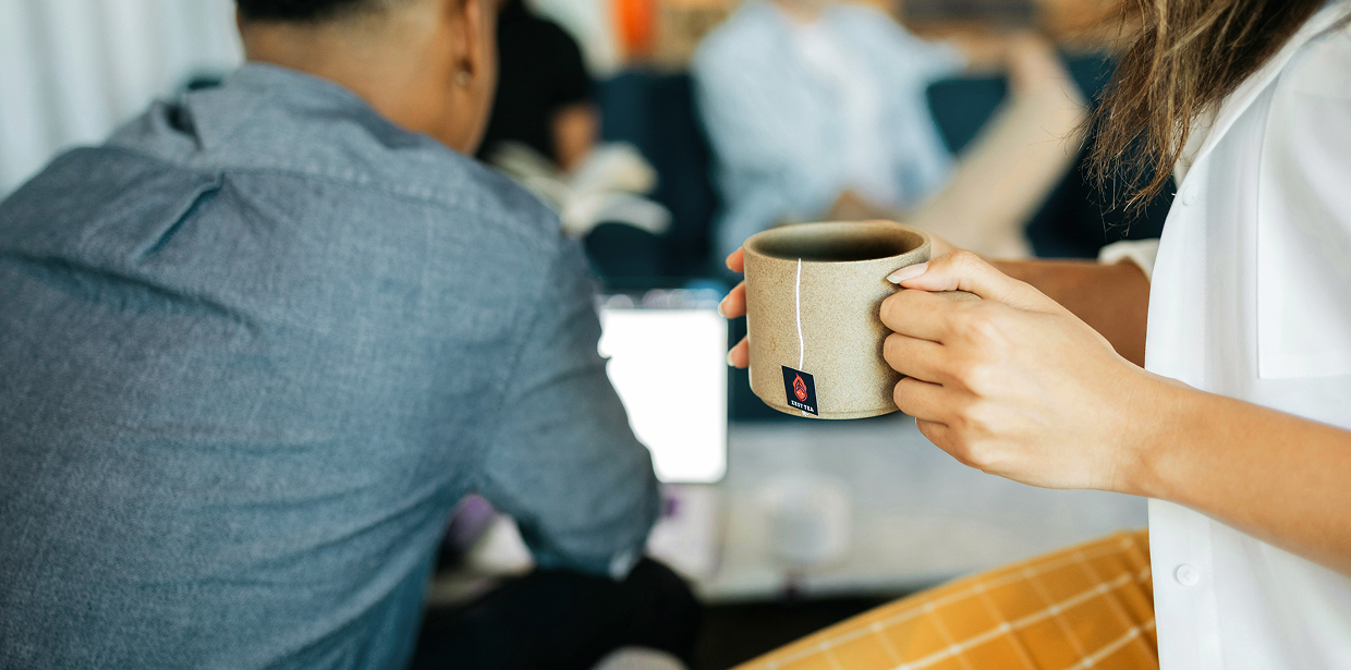 People having coffee during a meeting at a coworking space