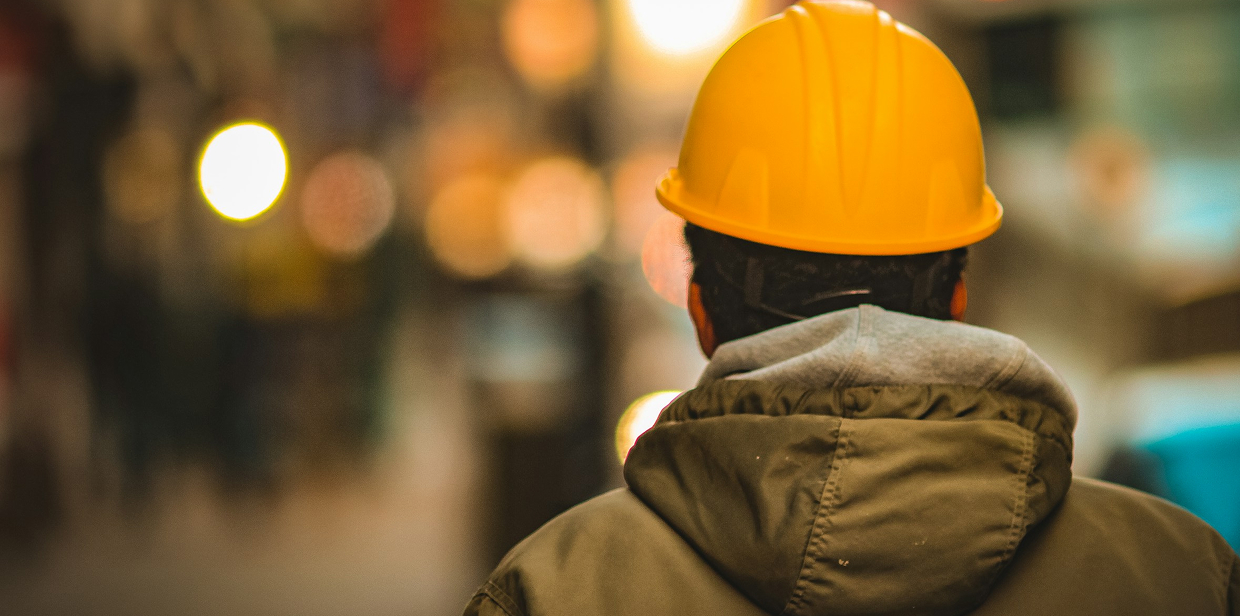 Industrial worker in a hard hat and safety jacket