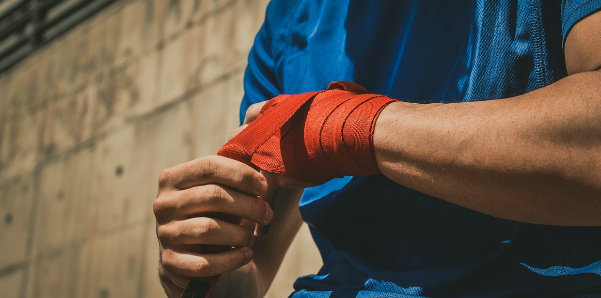 Worker wrapping injured hands with a bandage