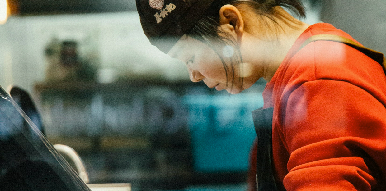 A young woman focused on work at a service counter